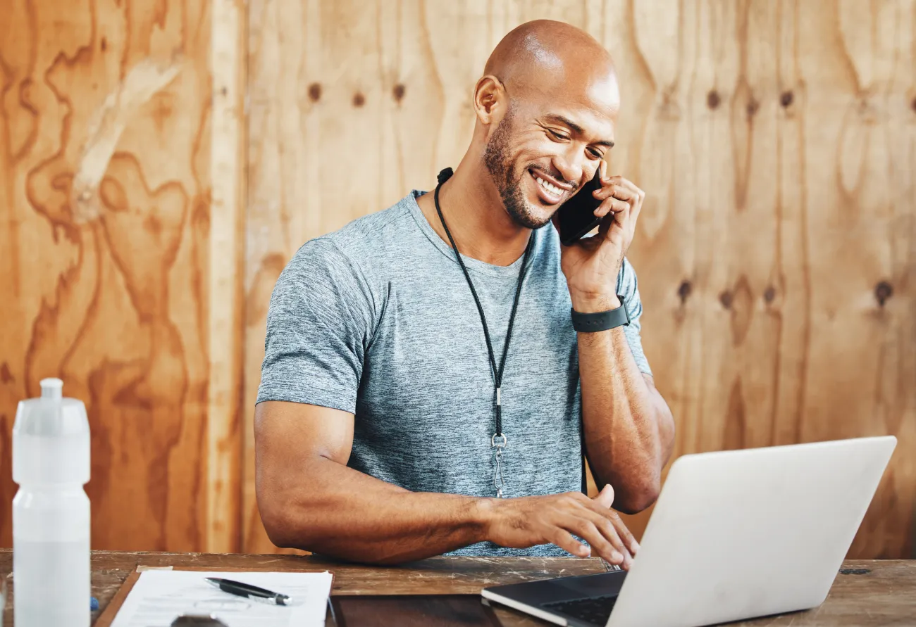 Receptionist taking a prospect call at a gym front desk